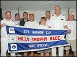  Rear commodore John Sokol, left, and vice commodore Tom Kaintz, second from right, present a flag to the winning crew of the Governor’s Cup after the Mills Trophy Race. Crew members include, beginning second from left, Tom Morgan, Steve King, John Bollin, Robert Bollin, Joe DiMasso, and Bill Bollin, far right.