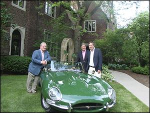 From left, host Carl Hedlund, Greg Knudson and Tom Downs stand next to a 1963 Jaguar that was on display to commemorate the 50-year members at the Country Garden Club's Tea and Wine soiree.