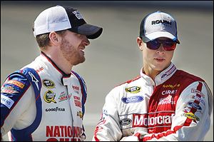 Dale Earnhardt, Jr., left, talks to fellow driver Trevor Bayne during qualification for today's race. Earnhardt has been competitive but has yet to win this season.