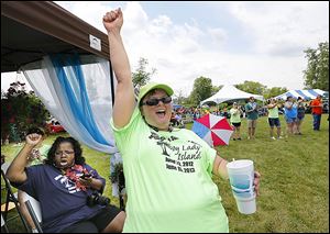 Debie Brakke of Adrian raises a cheer during the second annual Middle Class Survival Rally in Monroe on Saturday.
