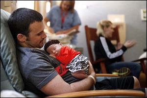 Chad Bingley holds his daughter, Kyra Ryan, shortly before she was discharged from the neonatal intensive care unit at Mercy Children's Hospital.
