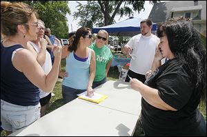 From left, Denise Yanez of Oregon, Debbie Russeau of Toledo, Heather Walker of Maumee, Amy Hofner of Bowling Green, and Todd Galpal of Toledo are assigned to a team as Risa Smith, right, coordinates search groups Saturday in East Toledo. 