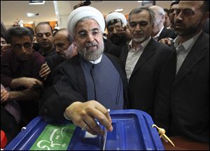 Iranian presidential candidate Hasan Rowhani, a former Iran's top nuclear negotiator, casts his ballot during presidential elections at a polling station in downtown Tehran, Iran, Friday. He was declared the winner of Iran’s presidential vote today.