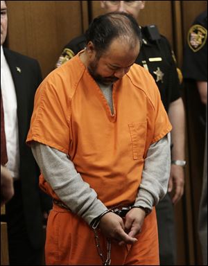 Ariel Castro walks into the courtroom for his arraignment Wednesday, June 12, 2013, in Cleveland. Castro, accused of holding three women captive in his Cleveland home for about a decade, pleaded not guilty Wednesday to hundreds of charges, including rape and kidnapping. He is charged with kidnapping three women and keeping them _ sometimes restrained in chains _ along with a 6-year-old girl he fathered with one of them.  (AP Photo/Tony Dejak)