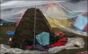 A protester sleeps under a plastic sheet at the Gezi Park of the Taksim Square in Istanbul early today.