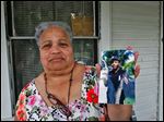  Linda Watson holds a photo of her nephew Frederick D. Watson, Jr., who was found shot to death in a car early Sunday morning.