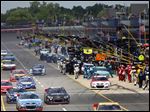  Cars exit pit road during a caution at the Quicken Loans 400. There were eight cautions in the race.