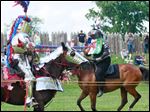  Tom Nader, riding Maggie, left, jousts with his wife, Kim Nader, riding Nemesis, during Muster on the Maumee on Sunday at Fort Meigs in Perrysburg. The Naders live in Greenville, Ohio.