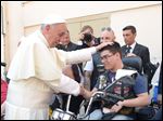  Pope Francis blesses a man in Harley-Davidson garb while spending time chatting with sick and disabled persons after the Mass in St. Peter’s Square.