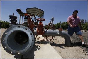 Farmer David Schwabauer, a partner/manager of Leavens Ranches, a fourth-generation avocado and lemon grower, tours his property irrigation system in Moorpark, Calif. The Schwabauer family has been considering allowing energy companies to drill new exploratory wells in their orchards in Moorpark, in the arid foothills just east of coastal Ventura, Calif. But the trees in Moorpark rely on irrigation supplies drawn from a depleted aquifer, and the county is already in drought. Drilling for oil, especially using hydraulic fracturing techniques, requires a lot of water as well, so the family has been divided on whether to go ahead with the offer.