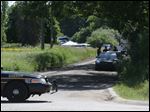  Law enforcement officials block the street to the scene in Oakland Township, Mich., where officials search for the remains of Teamsters union president Jimmy Hoffa.