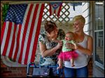  Sandra Vollmar, left, and Swanton resident Alexa Albring hold Ms. Albring's daughter, Aubri Berfield, 6 months, at Mrs. Vollmar's home in South Toledo. Ms. Vollmar was babysitting Aubri last month when she was struck by a hit-and-run driver. She managed to save the infant from injury.