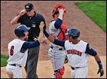  Toledo’s Brad Davis greets Argenis Diaz after they both scored on Diaz’s two-run home run in the fourth inning on Monday night. Nearly every Mud Hen had two hits in the win over Lehigh Valley.