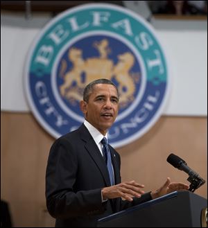President Barack Obama gestures during a speech at the Belfast Waterfront Hall today in Belfast, Northern Ireland. 