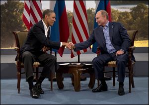 President Barack Obama and Russian President Vladimir Putin shake hands in Northern Ireland as they talk about their difference on Syria. 