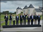  G-8 leaders from left, European Commission President Jose Manuel Barroso, Japan's Prime Minister Shinzo Abe, German Chancellor Angela Merkel, British Prime Minister David Cameron, U.S. President Obama, Russian President Vladimir Putin, French President Francois Hollande, Canadian Prime Minister Stephen Harper, Italian Prime Minister Enrico Letta and European Council President Herman Van Rompuy walk to a group photo opportunity during the G-8 summit at the Lough Erne golf resort in Enniskillen, Northern Ireland.