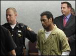  Keshawn Jennings is ushered into Lucas County Common Pleas Court.