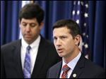  FBI Assistant special agent Eric Smith, right, answers questions during a news-conference about three people arrested on charges of enslaving a disabled young mother and her daughter. U.S. attorney Steven M. Dettelbach is at left.