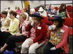  Susan Mutschler, of Sylvania, center left, and Mary Patterson, of Perrysburg, right, sipped their tea while wearing similar hats during a 