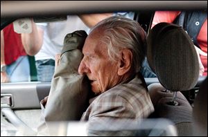 Alleged Hungarian war criminal Laszlo Csatary sits in a car as he leaves the Budapest Prosecutor's Office in July, 2012.