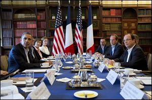 President Barack Obama meets with French President Francois Hollande during the G-8 summit, where discussions included globe-trotting corporate tax dodgers and Syria'ss civil war.