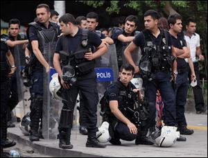 Riot police stand by near a rally by the labor unions in Ankara, Turkey, Monday. A day earlier, riot police cordoned off streets, set up roadblocks and fired tear gas and water cannons to prevent anti-government protesters from an effort to return to Taksim Square in Istanbul