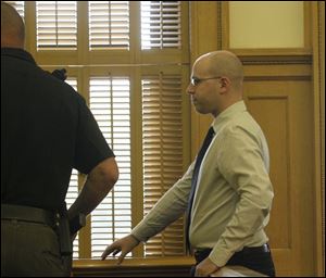 John T. Millinger, a former Wood County Park District ranger, leaves the courtroom after being  sentenced for placing cameras in park restrooms and other locations to film women undressing in the Wood County Courthouse.