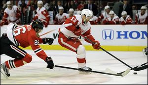 Detroit Red Wings' Pavel Datsyuk (13) controls the puck past Chicago Blackhawks ' Michal Handzus (26) during the first period of Game 1 of an NHL hockey playoffs Western Conference semifinal in Chicago on May 15.