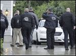  State and local police gather outside the home of New England Patriot's NFL football player Aaron Hernandez in North Attleborough, Mass., Tuesday.