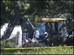  Members of an FBI evidence response team look over an area being cleared in Oakland Township, Mich., Tuesday, where officials were searching for the remains of Teamsters union president Jimmy Hoffa.