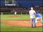  Mark Feldstein of  Sylvania, Ohio, throws out the first pitch at Wrigley Field on June 1 in Chicago.