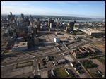  FILE - In this June 14, 2012, an aerial view of downtown Detroit shows parking lots behind The Fox Theatre and the State Theatre. The Detroit Red Wings and city official announced Wednesday, June 19, 2013, a $650 million plan for a new arena for the NHL team in the city's downtown entertainment and sports district. Red Wings and Tigers owner Mike Ilitch has long said that he wants a replacement for the 32-year-old Joe Louis Arena. (AP Photo/Detroit Free Press, Romain Blanquart, File)  DETROIT NEWS OUT; TV OUT; INTERNET OUT; MAGS OUT; NO SALES; MANDATORY CREDIT