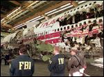  FBI agents and New York state police guard the reconstruction of TWA Flight 800 in Calverton, N.Y., in November, 1997. Flight 800 exploded and crashed July 17, 1996 while flying from New York to Paris, killing all 230 people aboard. 