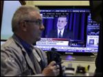  Stocks dropped after Fed Chairman Ben Bernanke, shown in background on television, offered a hint Wednesday that it's moving closer to slowing its bond-buying program, which is intended to keep long-term interest rates at record lows. 