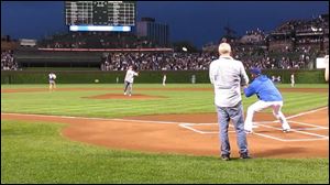 Mark Feldstein of  Sylvania, Ohio, throws out the first pitch at Wrigley Field on June 1 in Chicago.