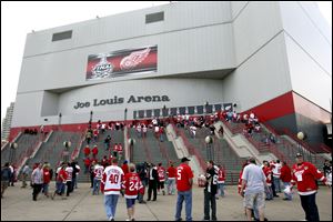FILE - In this May 31, 2009, file photo, hockey fans enter Joe Louis Arena for Game 2 of the NHL Stanley Cup Finals hockey series in Detroit. The Detroit Red Wings and city official announced Wednesday, June 19, 2013, a $650 million plan for a new arena for the NHL team in the city's downtown entertainment and sports district. Red Wings and Tigers owner Mike Ilitch has long said that he wants a replacement for the 32-year-old Joe Louis Arena. (AP Photo/Carlos Osorio, File)