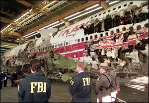 FBI agents and New York state police guard the reconstruction of TWA Flight 800 in Calverton, N.Y., in November, 1997. Flight 800 exploded and crashed July 17, 1996 while flying from New York to Paris, killing all 230 people aboard. 