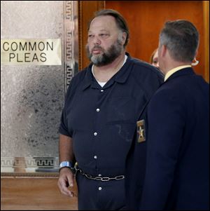 Andrew Gustafson leaves Lucas County Common Pleas Court following his arraignment on Wednesday, June 12, 2013. He was indicted last week for the 1983 murder of Janean Brown in Whitehouse.