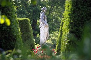 A sculpture of a young woman in the Toledo Botanical Garden.