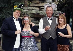 From left, Ian Hartten, Lisa Reichert, Mike Sager, and his wife Kris raise their glasses, dressed in festive animal-friendly wear at the Toledo Zoo’s ZOOtoDo.