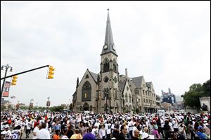 The crowd fills the street in front of The Central United Methodist Church on the corner of Woodward Avenue and Adams.