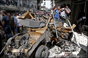 Syrians investigate damages after two suicide bombings hit security compounds in Damascus, Syria, today.