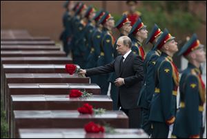 Russian President Vladimir Putin takes part in a wreath laying ceremony at the Tomb of the Unknown Soldier outside Moscow's Kremlin Wall in Moscow on Saturday to mark the 72nd anniversary of the Nazi invasion of the Soviet Union.