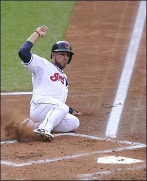 Cleveland Indians' Mike Aviles scores a run on a two-run double by Jason Kipnis in the first inning of a baseball game against the Minnesota Twins.