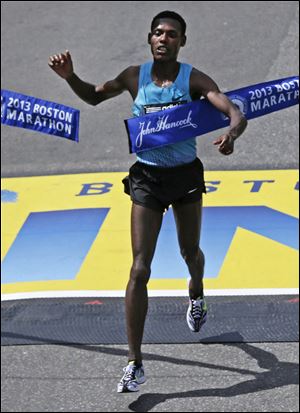 Lelisa Desisa, of Ethiopia, breaks the finish line tape to win the 2013 running of the Boston Marathon in April.
