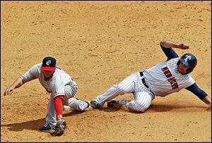 The Hens’ Kevin Russo slides into second base safely while Jonathan Diaz was late in making the tag.