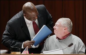 Toledo Councilman and mayoral candidate D. Michael Collins, right, and Mayor Mike Bell released personal financial documents Monday that showed healthy incomes and high credit scores.
