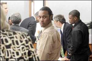 Keshawn Jennings, left, and Antwaine Jones, right, stand at the defendants table after opening statements in the murder case of 1-year-old Keondra Hooks, who was shot to death in the Moody Manor apartments, at the Lucas County Courthouse.