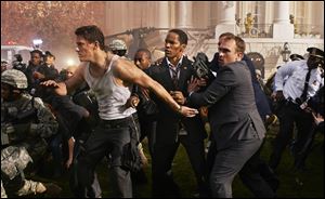 Channing Tatum, left, and Jamie Foxx, center, star in Columbia Pictures' 
