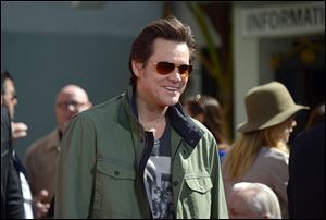 Jim Carrey says he isn't ashamed of his role in 'Kick-Ass 2' but the Connecticut shootings have caused him to have a change of heart. 